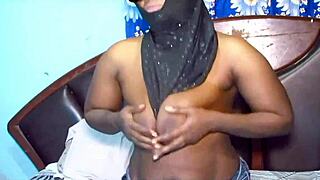 This hijab milf is playing with her big tits and spreading her legs wide.