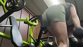 Young slim gymnast trains and pleases herself