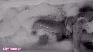 KITY HUDSON ENJOYS BATH WITH TOY