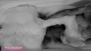KITY HUDSON ENJOYS BATH WITH TOY
