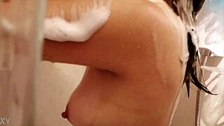 A mature woman with an hour-glass figure and big boobs has a shower
