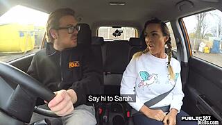 A mature woman with large breasts has sex in a driving school car in a public place