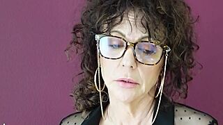 A beautiful mature brunette shares her story with glasses and curly hair, feeling cute and emotional in her solo softcore moment.