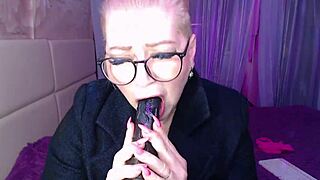 Busty vulgar mature whore in glasses flaunts ponytail and dirty talk.