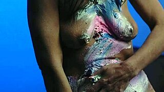 Messy birthday cake girl plays with food on natural tits