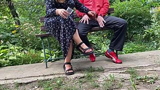 Hot milf jerks off a big dick into a glass on a park bench in this kinky public fetish scene