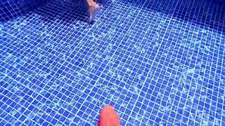 Woman surprised while relaxing in the pool water