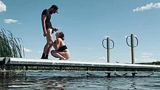 Couple risks getting caught fucking outdoors at the lake. They expose big natural tits and perform blowjob for anyone to watch.
