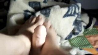 In a dominant scene, the milf gives an intense footjob while teasing her pussy.