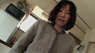 makiko nakane, the mature asian brunette with hairy pussy, bends over on bed for doggystyle fucking and anal fingering with a guy in fishnets lingerie.