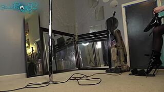 Brunette ballerina in black lingerie and hobble boots vacuums the house with long hair flowing.