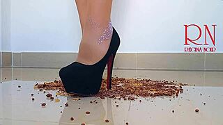 Brunette curvy femdom in boots and lingerie destroys cornflakes with high heels on dorm floor. Party maid scene with gaping and submissive naked action.