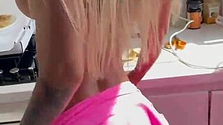 Gorgeous monika fox slips out of her pink bodysuit to reveal pierced nipples and shaved pussy in the kitchen.