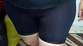 señora with big ass in shiny spandex leggings shows off her curves