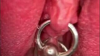 Close-up shows my pissing shaved pussy with pierced clit in outdoor solo moment.