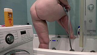 a busty milf wife shaves her thick legs in the bathroom camera view